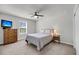 Neutral bedroom with a ceiling fan, dresser with TV, and large window at 2109 Rowan Rd, Johns Island, SC 29455