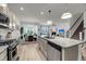 Modern kitchen with granite countertops and stainless steel appliances flows into the dining and living area at 2109 Rowan Rd, Johns Island, SC 29455