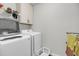 Bright laundry room featuring a washer, dryer, white cabinets, and shelving for storage at 2109 Rowan Rd, Johns Island, SC 29455