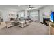 Cozy living room with a fireplace, large grey sofa, and neutral decor at 2109 Rowan Rd, Johns Island, SC 29455