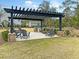 Relaxing outdoor lounge area with pergola, stylish seating, and well-maintained landscaping at 2109 Rowan Rd, Johns Island, SC 29455