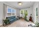 Bright sitting room with large windows, stylish sofa, and natural light at 2109 Rowan Rd, Johns Island, SC 29455