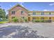 A two-story building with brick and yellow siding, covered porches, and ample parking space at 2150 Spoleto Ln # H2, North Charleston, SC 29406