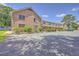 Apartment complex featuring brick facade, a covered porch, and ample parking space for residents and visitors at 2150 Spoleto Ln # H2, North Charleston, SC 29406