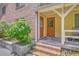 Apartment building's entrance showcases a brick facade, a charming covered porch, and brick steps at 2150 Spoleto Ln # H2, North Charleston, SC 29406