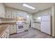 Traditional kitchen with white cabinets, laminate countertops, white appliances and modern flooring at 2150 Spoleto Ln # H2, North Charleston, SC 29406