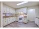 Well-lit kitchen with white cabinets, and ample countertop space for meal preparation and storage at 2150 Spoleto Ln # H2, North Charleston, SC 29406