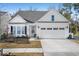 Charming one-story home featuring a two-car garage, manicured lawn, and classic architectural details at 218 River Martin Ct, Summerville, SC 29483