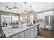 Spacious kitchen with a large island, pendant lighting, and stainless steel appliances offering plenty of room to cook at 218 River Martin Ct, Summerville, SC 29483