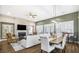 Open concept living area with a fireplace, modern furnishings, and natural light creating a warm, inviting atmosphere at 218 River Martin Ct, Summerville, SC 29483