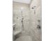 Close up of elegant tiled shower with dual showerheads and built-in bench at 218 River Martin Ct, Summerville, SC 29483
