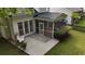 Backyard exterior view with screened porch, patio, green grass, and landscaping at 2204 Andover Way, Mount Pleasant, SC 29466