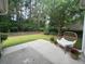 Green backyard area with patio, grass, flower pots, and lounge chair at 2204 Andover Way, Mount Pleasant, SC 29466