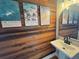 Bathroom features a vessel sink, wood accent wall, and decorative artwork at 2204 Andover Way, Mount Pleasant, SC 29466