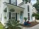 Charming front porch with a bright blue door, decorative plants, and the home's street address at 2204 Andover Way, Mount Pleasant, SC 29466