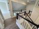 Upstairs hallway with beautiful wood flooring, railing, and natural light at 2204 Andover Way, Mount Pleasant, SC 29466