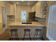 Modern kitchen with granite countertops, stainless steel appliances, and three barstools at the island at 2204 Andover Way, Mount Pleasant, SC 29466