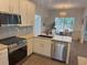 Bright kitchen with stainless steel appliances, granite counters and a view of the dining area at 2204 Andover Way, Mount Pleasant, SC 29466