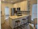Modern kitchen with granite countertops, stainless steel appliances, and three barstools at the island at 2204 Andover Way, Mount Pleasant, SC 29466