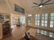 Open-concept living area leading to a dining room, featuring large windows and a modern ceiling fan at 2204 Andover Way, Mount Pleasant, SC 29466