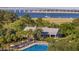 Stunning aerial shot showcases pool, beautiful foliage, and waterfront views at 2431 Settlers St, Charleston, SC 29492