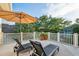 Relaxing balcony area furnished with lounge chairs and a sun umbrella, perfect for outdoor leisure at 2431 Settlers St, Charleston, SC 29492