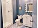 Modern bathroom with navy walls, a glass-enclosed shower, and stylish tile flooring at 2431 Settlers St, Charleston, SC 29492