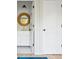 Elegant bathroom featuring white cabinets, gold fixtures, a circular mirror, and hexagonal tiled floors at 2431 Settlers St, Charleston, SC 29492