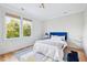 Bright bedroom featuring a plush bed with a blue headboard and large windows overlooking mature trees at 2431 Settlers St, Charleston, SC 29492