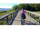 Scenic view of a Personal and dog riding on a bicycle on a wooden bridge near the community's waterfront at 2431 Settlers St, Charleston, SC 29492
