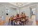 Formal dining room with modern chandelier, hardwood floors, and view of the staircase at 2431 Settlers St, Charleston, SC 29492