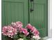 Pink Hydrangeas at front door with black hardware accenting a green entrance at 2431 Settlers St, Charleston, SC 29492