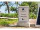 Signage indicating direction to Daniel Island Ferry Landing near a landscaped walkway at 2431 Settlers St, Charleston, SC 29492