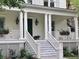 Inviting front porch with white columns, planter boxes, and a well-manicured garden at 2431 Settlers St, Charleston, SC 29492