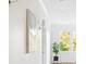 Bright and inviting hallway showcasing decorative wall art, a potted plant, and a window with natural light at 2431 Settlers St, Charleston, SC 29492