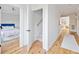 Bright hallway with hardwood floors leading to a bedroom and staircase, showcasing an open floorplan at 2431 Settlers St, Charleston, SC 29492