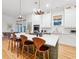 Open kitchen with a center island, modern pendant lighting, and bright white cabinetry at 2431 Settlers St, Charleston, SC 29492