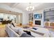 Open-concept living room has a fireplace, built-in shelves, and a comfortable, oversized sectional at 2431 Settlers St, Charleston, SC 29492