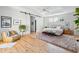 Well-lit main bedroom featuring hardwood floors, a comfortable seating area, and neutral décor throughout at 2431 Settlers St, Charleston, SC 29492