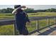 A view of a marsh as seen from a wooden boardwalk where a person is holding a dog at 2431 Settlers St, Charleston, SC 29492