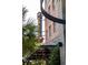 Exterior view of New Realm restaurant with neon sign and outdoor seating at 2431 Settlers St, Charleston, SC 29492