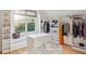 Bright walk-in closet featuring custom shelving, storage, natural light, and wood flooring at 2431 Settlers St, Charleston, SC 29492