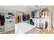Spacious walk-in closet with custom white cabinets, drawers, shelving, and hardwood floors at 2431 Settlers St, Charleston, SC 29492