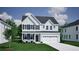 Charming two-story home featuring a covered entryway, attached two-car garage, and manicured lawn at 2476 Grange Cir, Summerville, SC 29486