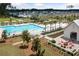 Community pool area with plenty of lounge chairs and a fire pit with Adirondack chairs at 262 Great Lawn Dr, Summerville, SC 29486