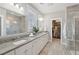 Spacious bathroom featuring double sinks, a walk-in closet, and a glass shower at 262 Great Lawn Dr, Summerville, SC 29486