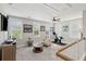Bright bonus room with a ceiling fan, exercise bike, and multiple windows allowing ample natural light at 262 Great Lawn Dr, Summerville, SC 29486