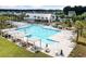 Aerial view of a community pool with a lap pool, lounge chairs, covered seating and shade at 262 Great Lawn Dr, Summerville, SC 29486