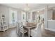 Dining room with wood floors, white trim, chandelier and natural light, open to other living spaces at 262 Great Lawn Dr, Summerville, SC 29486
