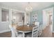 Spacious dining room with chandelier and wood floors, open to the staircase and office at 262 Great Lawn Dr, Summerville, SC 29486